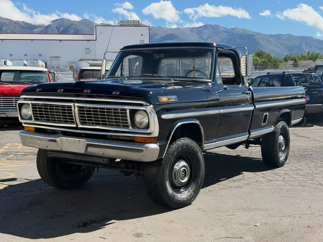 Blue classic Ford Highboy outside the shop