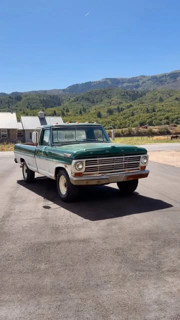 Vintage green Ford truck at the foot of Utah mountains